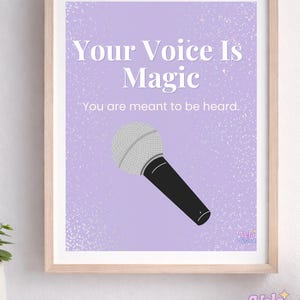 May include: Framed art print with the text "Your Voice Is Magic" and "You are meant to be heard." A microphone illustration is featured on a lavender background. The print is in a light wood frame.