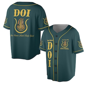 May include: Two teal baseball jerseys. One jersey has "DOI" and an Egyptian-themed graphic on the back. The other jersey has "DOI" vertically, with "Your Name" above and "Your Court #86" with a graphic and "Oasis of Memphis Desert of Tennessee" below.