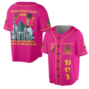 May include: Two hot pink baseball jerseys with yellow trim. One jersey's back features a graphic of a building, a woman's bust, and text that reads "YOUR COURT NAME 168 Oasis of Columbus Desert of Mississippi". The other jersey has the same text on the front.