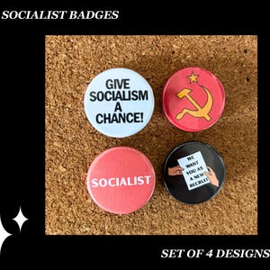 May include: A set of four socialist badges. One badge is white with the text "GIVE SOCIALISM A CHANCE!". Another is red with a hammer and sickle. A third is red with the word "SOCIALIST". The last is black with the text "WE WANT YOU AS A NEW RECRUIT".