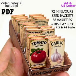May include: A collection of 72 miniature seed packets in 58 varieties, displayed in a small box. The packets feature illustrations of vegetables like tomatoes and garlic with text labels. Includes PDF, video tutorial, A4 and US Letter formats.