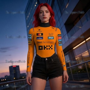 May include: Orange and black long-sleeve bodysuit with sponsor logos, including "Android," "Cisco," and "Dell Technologies." The bodysuit has a black turtleneck and is paired with black denim shorts. The text "RICHARD MILLE" is printed on the sleeves.
