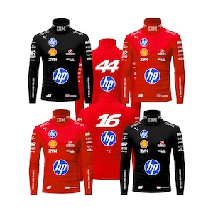 May include: A collection of long-sleeve mock neck shirts in black and red, featuring various sponsor logos including HP, Shell, and IBM. The shirts display racing numbers 44 and 16, along with the names Lewis and Charles, and small national flags.