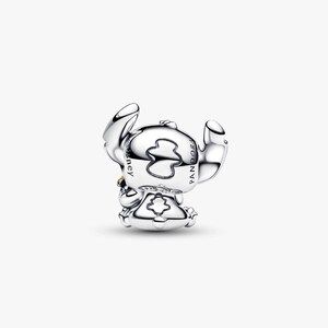 May include: A silver charm depicting the character Stitch from the Disney movie Lilo & Stitch. The charm is in a sitting pose with large ears and a small yellow detail. The charm is marked with the Disney and Pandora logos.