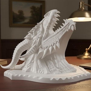 May include: A white dragon head sculpture with open jaws, showcasing detailed teeth and textured scales. The sculpture sits on a white base, displayed on a wooden desk. The dragon head is a fantasy-themed decorative item.