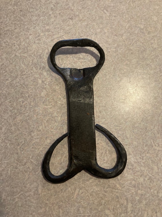 A hand-forged phallic bottle opener that doubles as a bachelorette/bachelor party gag gift — crude, funny, and actually blacksmith-made.