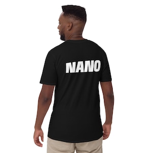 May include: Black t-shirt with the word "NANO" printed in bold white letters across the back. The shirt is short-sleeved and appears to be made of a soft material. The person wearing the shirt is facing away from the camera.