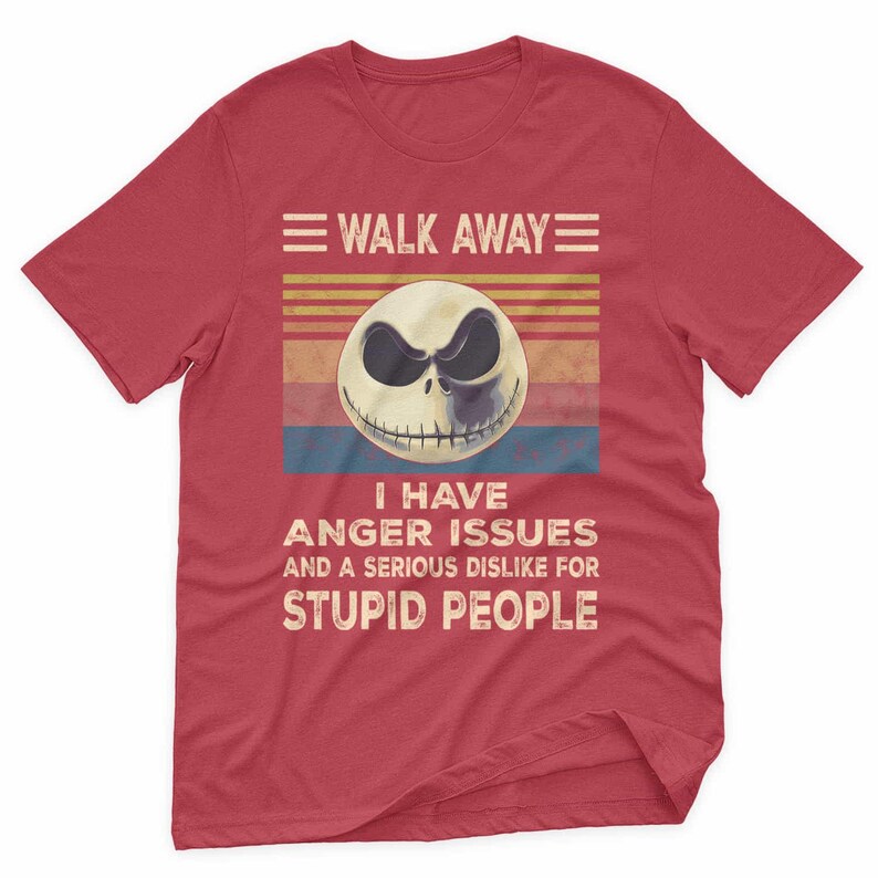 May include: Red t-shirt featuring a graphic of a skull with the text "WALK AWAY" above and "I HAVE ANGER ISSUES AND A SERIOUS DISLIKE FOR STUPID PEOPLE" below. The skull has a black eye and a sinister grin.