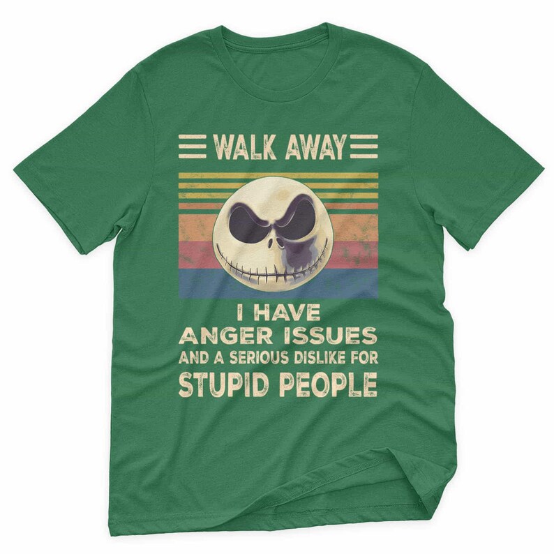 May include: Green t-shirt featuring a graphic of a skull with the text "WALK AWAY" above and "I HAVE ANGER ISSUES AND A SERIOUS DISLIKE FOR STUPID PEOPLE" below. The skull has a black and white design.