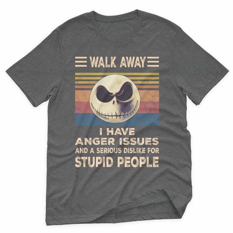 May include: Dark gray t-shirt with a graphic featuring a skull face with the text "WALK AWAY" above and "I HAVE ANGER ISSUES AND A SERIOUS DISLIKE FOR STUPID PEOPLE" below. The graphic has a retro color scheme.