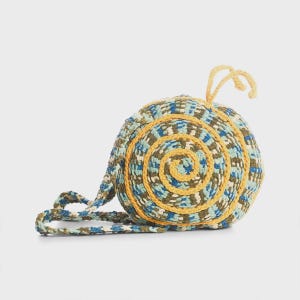 May include: A white ceramic mug with a black handle and the text "But First, Coffee" in a bold, black font. The mug is set against a neutral background, highlighting its simple design.