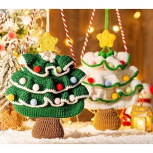 May include: Two handmade crochet Christmas tree ornaments. One is green with white trim and colorful pom-poms, the other is white with green trim and colorful pom-poms. Each has a brown trunk and a yellow star on top.