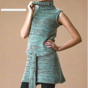 May include: A sleeveless turtleneck dress in a seafoam green and brown knit pattern. The dress has a matching belt and a flared skirt. The text "sleeveless turtleneck dress" is in the upper left corner. The dress is worn by a person.
