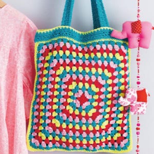 May include: A colorful crochet tote bag with a granny square design in red, pink, yellow, and teal. The bag has teal handles and trim, with a yellow border. A pink elephant decoration hangs on the side.