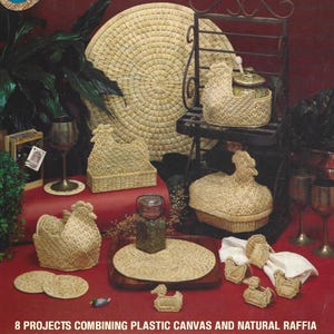 May include: A collection of raffia and plastic canvas crafts, including a chicken-shaped basket, coasters, and a large circular placemat. The items are arranged on a red surface with a dark background. The text at the bottom reads "8 PROJECTS COMBINING PLASTIC CANVAS AND NATURAL RAFFIA."