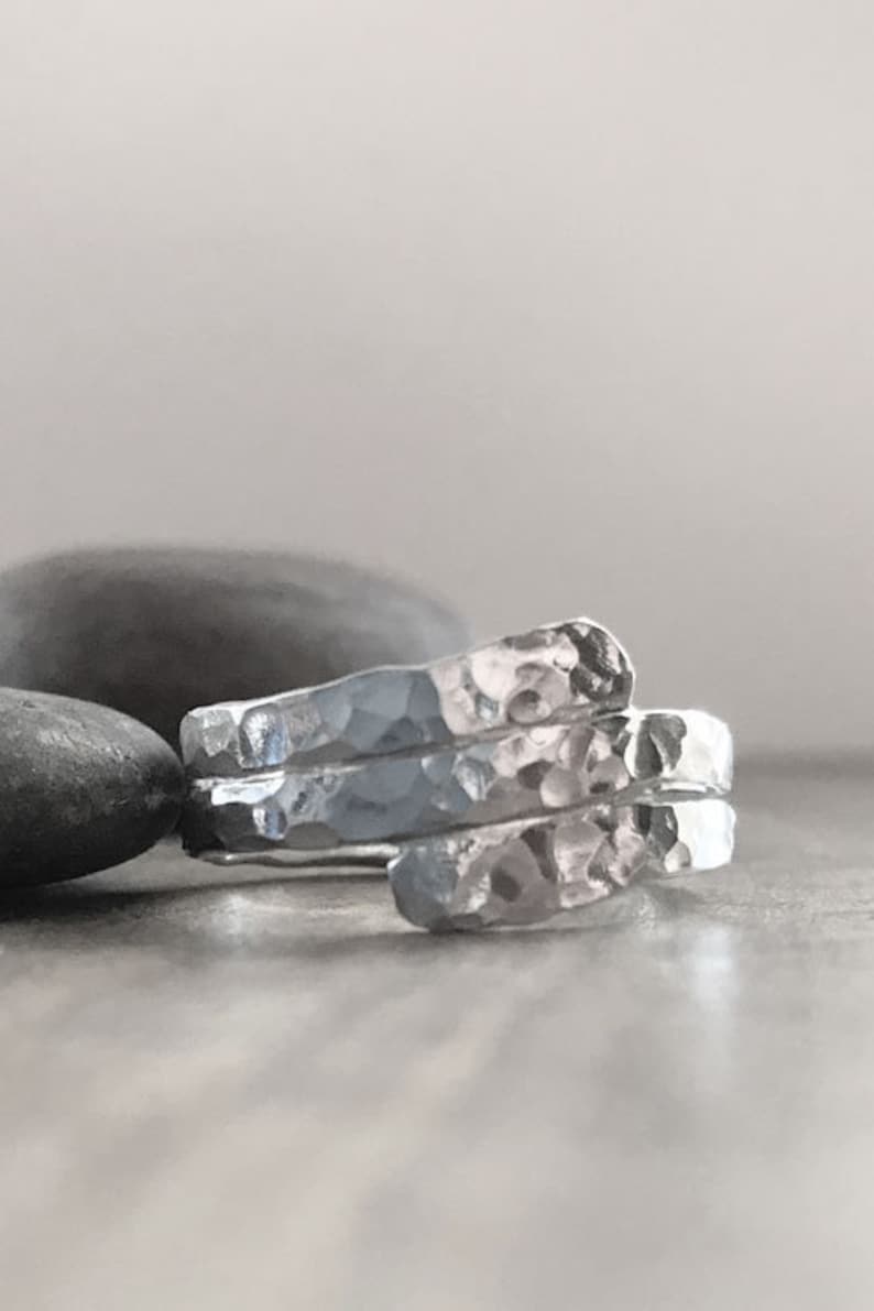 Hand made sterling silver ring that wraps around your finger like a hug. This ring has a hammered finish. Made to hold securely contain cremation ash, hair or fur.