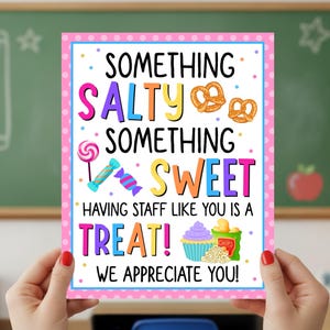 May include: A colorful classroom appreciation sign with the words "Something Salty, Something Sweet, Having Staff Like You Is A Treat! We Appreciate You!" The sign features images of pretzels, candy, a cupcake, and chips.