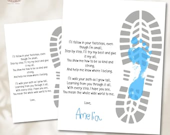 May include: Two white prints with a gray footprint design and a blue footprint. The prints contain the text "I'll follow in your footsteps..." and "Love, Amelia". The prints are a sentimental gift.