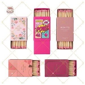 May include: Five decorative matchboxes with pink match heads. The boxes feature floral, comic book, and geometric designs. Text includes "MY MATCH BOX", "POW!", "MINITO", "BEST BATTOIN FOX", and "MAKE IT COUNT".