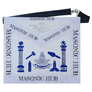 May include: White Masonic apron with blue embroidered symbols and the text "MASONIC HUB". The apron has a black adjustable belt. The design includes a hammer, pillars, and a compass with a sun.