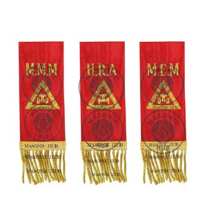 May include: Three red Masonic ribbons with gold fringe. Each ribbon features gold text and a gold emblem within a triangle. The text on the ribbons reads "M.M.M", "H.R.A", and "M.E.M". The bottom of each ribbon has the text "MASONIC HUB".