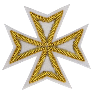 May include: A white Maltese cross-shaped emblem with gold-coloured embroidery. The gold embroidery outlines the cross shape and fills the interior spaces with intricate patterns. The emblem has a felt-like texture.