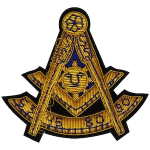 May include: Embroidered Masonic emblem featuring gold thread on a black background. The design includes a compass, square, and sun symbol, with blue accents and text. The emblem is likely for a fraternal organization.