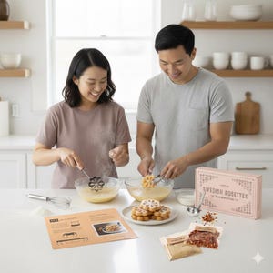 May include: A couple preparing Swedish rosette cookies in a bright kitchen. The image shows a box labeled "Swedish Rosettes" and a recipe card. Ingredients and tools, including a whisk and a measuring spoon, are visible.