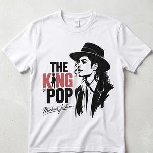 May include: White t-shirt with a black and red graphic of Michael Jackson. The design includes the text "THE KING OF POP" and a portrait of the singer in a hat and suit.
