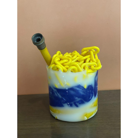 A wax-encrusted found-object sculpture fusing industrial chain and hose into a cabinet-of-curiosities art piece — genuinely one-of-a-kind weird.