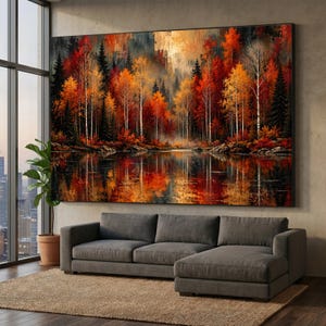 May include: A large rectangular wall art print depicting a dense forest landscape during autumn with vibrant red, orange, and yellow foliage reflected in a calm lake. The scene features tall slender trees and dark evergreen silhouettes.