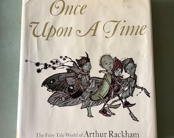 May include: A book titled "Once Upon A Time" with an illustration of fairies riding a large butterfly. The book is by Arthur Rackham and is about the fairy tale world.