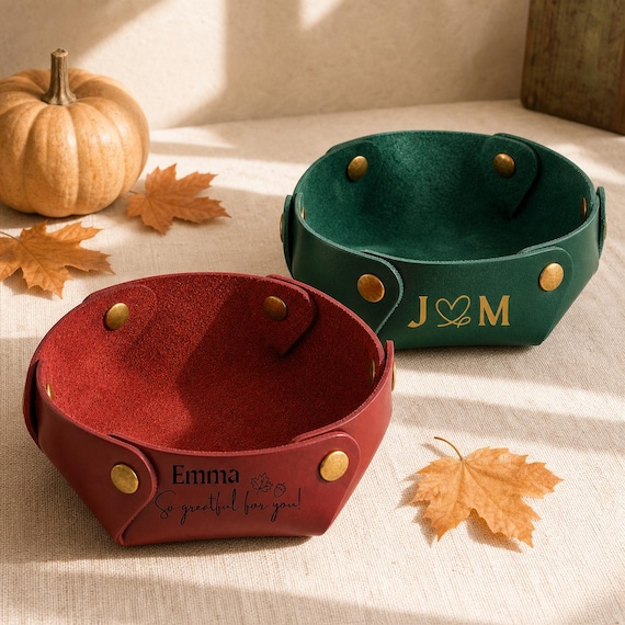 A hand-stitched custom leather valet tray that turns a 'thank you' into something the host will leave on their entryway table for years — far classier than a candle or wine.