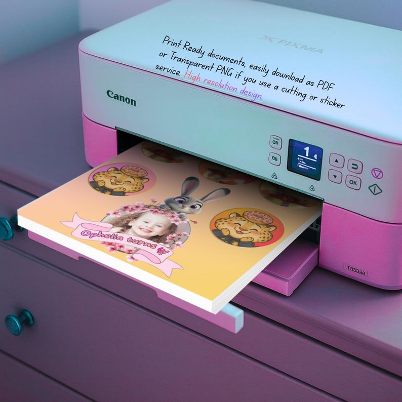 May include: A pink and white Canon Pixma printer printing a custom design. The design includes a child's photo, cartoon characters, and the text "Ophelia turns". The printer has a digital display and control buttons.