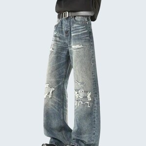 Distressed Washed Denim Jeans | Casual Wide Leg Pants | Grunge Y2K Streetwear

Distressed washed wide leg denim jeans with patch detailing styled for modern streetwear look.