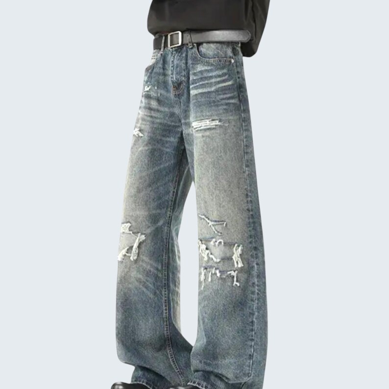 Distressed Washed Denim Jeans | Casual Wide Leg Pants | Grunge Y2K Streetwear

Distressed washed wide leg denim jeans with patch detailing styled for modern streetwear look.