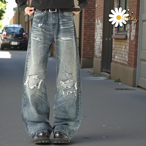 Distressed Washed Denim Jeans | Casual Wide Leg Pants | Grunge Y2K Streetwear

Distressed washed wide leg denim jeans with patch detailing styled for modern streetwear look.