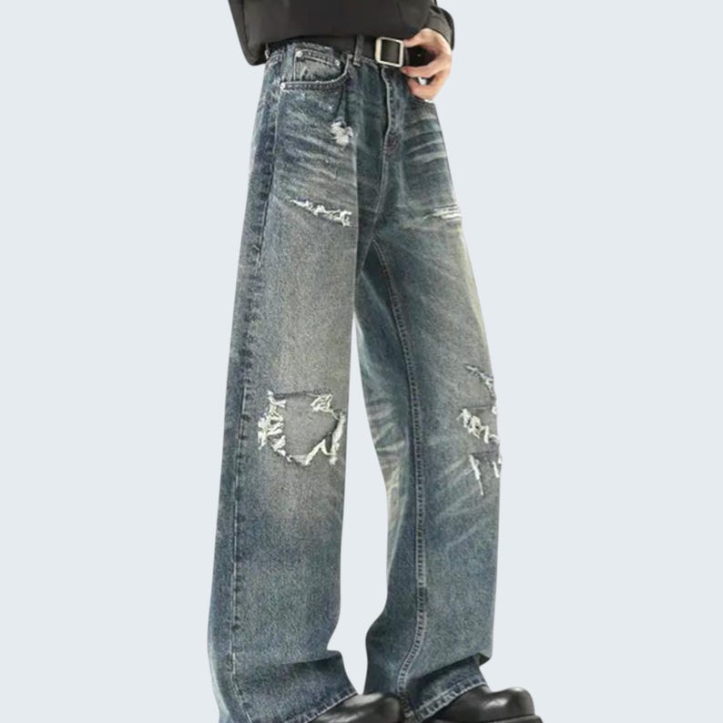 Distressed Washed Denim Jeans | Casual Wide Leg Pants | Grunge Y2K Streetwear

Distressed washed wide leg denim jeans with patch detailing styled for modern streetwear look.