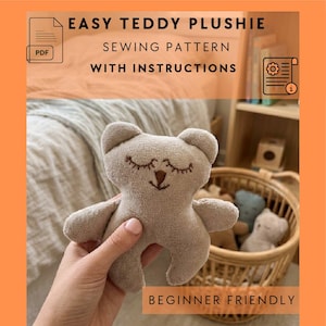 May include: A beige teddy bear plushie with embroidered eyes and a smiling mouth is held in a hand. The image includes text that reads "EASY TEDDY PLUSHIE SEWING PATTERN WITH INSTRUCTIONS" and "BEGINNER FRIENDLY". Other teddy bears are in a wicker basket.