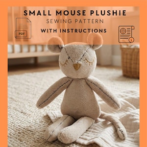 May include: A beige plush mouse with orange ears and closed eyes, sitting on a cream-colored blanket. The mouse has stitched details and a small yellow heart-shaped nose. Text at the top reads "SMALL MOUSE PLUSHIE SEWING PATTERN WITH INSTRUCTIONS."