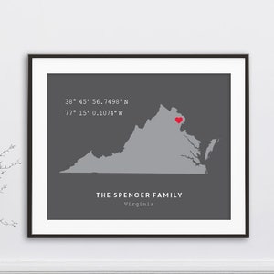 May include: A gray map of Virginia with a red heart marking the location of 38° 45' 56.7498"N 77° 15' 0.1074" W. The text "THE SPENCER FAMILY Virginia" is below the map.