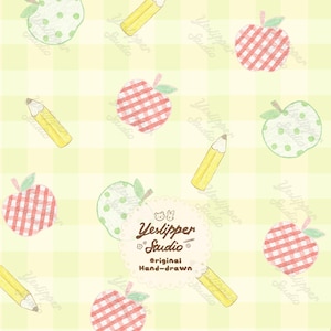 May include: A light yellow gingham patterned background featuring a repeating hand-drawn motif of red checkered apples, green polka-dot apples, and yellow pencils. A central scalloped circular label displays the text Yeslipper Studio.