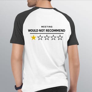 May include: White and charcoal raglan t-shirt with the text "MEETING WOULD NOT RECOMMEND" above a one-star rating. The single star is yellow, and the remaining four stars are outlined in black.