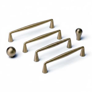 May include: A collection of bronze-colored cabinet hardware, including four pull handles and two knobs. The handles vary in design, with some featuring a textured center. The hardware is arranged on a white background, showcasing the different styles.