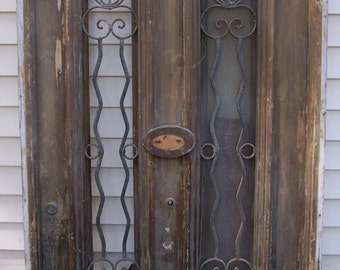 antique pediment windows with iron panels;salvage, iron window panel