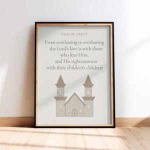May include: A framed print with the text "PSALM 103:17" and a religious quote. The image includes a beige illustration of a church with two towers. The frame is black, and the background is a light beige.