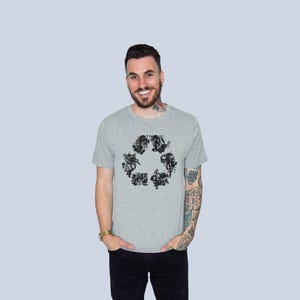 May include: A heather gray short-sleeve t-shirt featuring a black graphic print on the chest. The design is composed of various small, intricate illustrations arranged in the shape of a triangular recycling symbol, centered on the front.