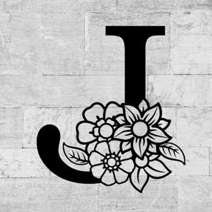 Może przedstawiać: Czarna kwiatowa litera "J" na szarym tle z cegieł. Litera ozdobiona jest szczegółowymi wzorami kwiatów i liści. Idealna do dekoracji wnętrz lub spersonalizowanych prezentów.