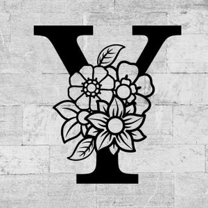May include: Black letter "Y" with a floral design. The letter is filled with a bouquet of flowers and leaves. The background is a light gray brick wall.