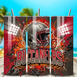 May include: A stainless steel tumbler featuring a Tampa Bay Buccaneers football helmet design. The tumbler has a red, gray, and orange color scheme with the word "BUCCANEERS" prominently displayed. Includes a silver straw.